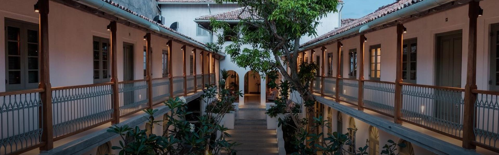 Fort Bazaar, a boutique hotel in galle, features a beautifully designed courtyard with lush greenery, arched entryways, and elegant architecture