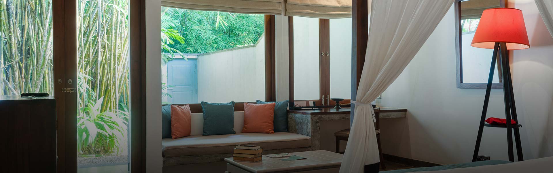 Walawwa, a luxury hotel in Colombo, offers a stylish indoor space with tropical aesthetics, comfortable seating, and natural light flowing.