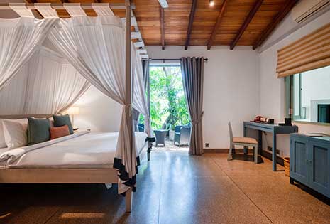 Relax in this calm and charming bedroom at The Wallawwa, a boutique hotel near Colombo Airport.